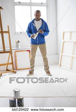 Black artist painting in studio View Large Photo Image Stock Image - Black artist painting in studio. Fotosearch