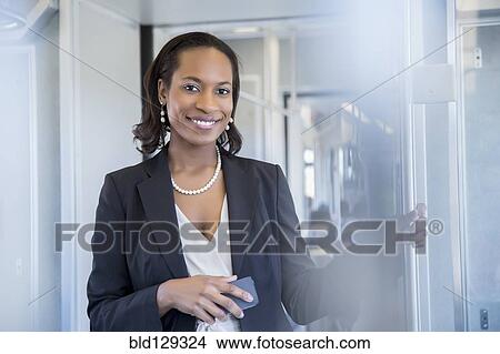 Black businesswoman smiling on train View Large Photo Image Picture - Black businesswoman smiling on train. Fotosearch