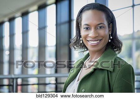 Picture - Black businesswoman smiling outdoors. Fotosearch