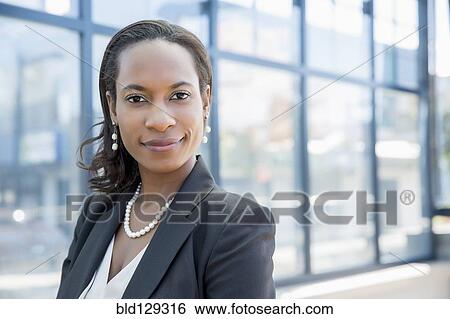 Black businesswoman smiling outdoors View Large Photo Image Stock Photograph - Black businesswoman smiling outdoors. Fotosearch