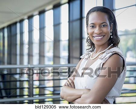 Stock Photography - Black businesswoman smiling outdoors. Fotosearch