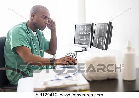 Black doctor working on computer in office View Large Photo Image Stock Image - Black doctor working on computer in office. Fotosearch