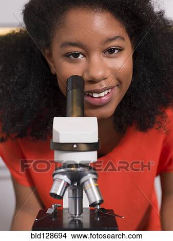 Black girl using microscope in chemistry lab View Large Photo Image Picture - Black girl using microscope in chemistry lab. Fotosearch