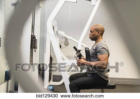 Black man lifting weights in gym View Large Photo Image Stock Image - Black man lifting weights in gym. Fotosearch
