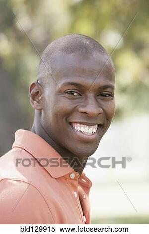 Stock Photography - Black man smiling outdoors. Fotosearch