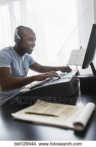 Black musician writing music on computer View Large Photo Image Picture - Black musician writing music on computer. Fotosearch