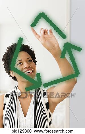 Black woman drawing green recycling symbol on window View Large Photo Image Stock Image - Black woman drawing green recycling symbol on window. Fotosearch