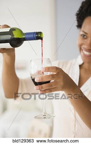 Black woman pouring glass of red wine View Large Photo Image Stock Image - Black woman pouring glass of red wine. Fotosearch
