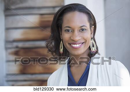 Black woman smiling outdoors View Large Photo Image Stock Image - Black woman smiling outdoors. Fotosearch