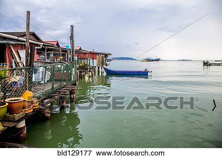 Boat docked along boathouses View Large Photo Image Stock Photo - Boat docked along boathouses. Fotosearch
