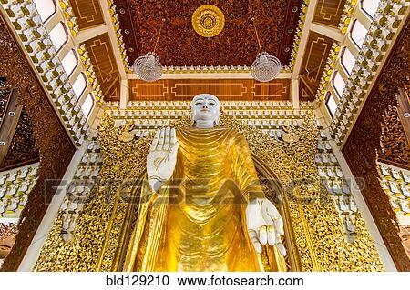 Stock Image - Buddha statue in Dhammikarama Burmese temple, George Town, Penang, Malaysia. Fotosearch