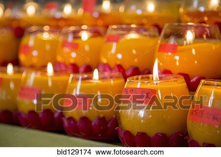 Picture - Burning candles for New Year in Buddhist temple. Fotosearch