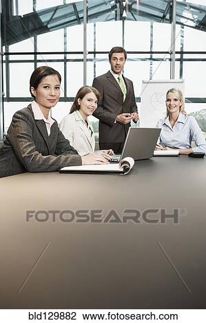 Business people sitting in meeting View Large Photo Image Stock Image - Business people sitting in meeting. Fotosearch