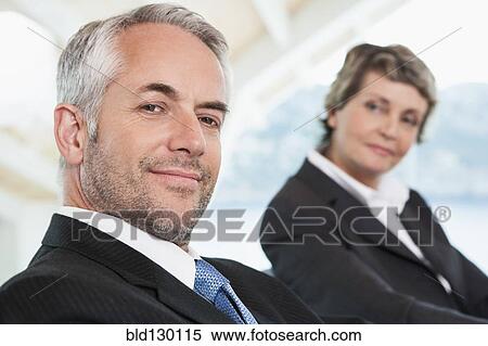 Stock Photography - Business people sitting in meeting. Fotosearch