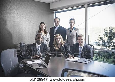 Stock Photo - Business people smiling in meeting. Fotosearch