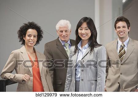 Stock Photo - Business people smiling in office. Fotosearch