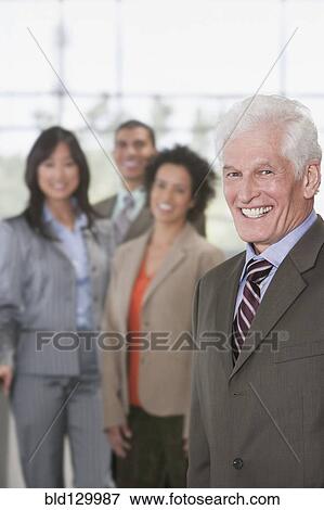 Stock Photo - Business people smiling in office. Fotosearch