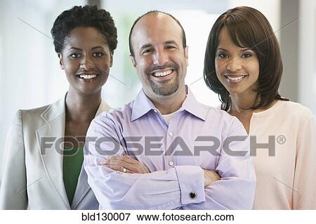 Stock Photo - Business people smiling in office. Fotosearch