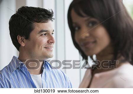Stock Photo - Business people smiling in office. Fotosearch
