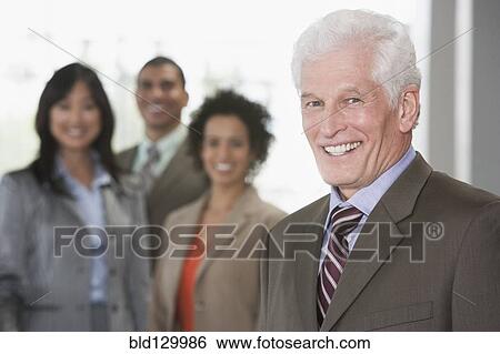 Stock Photograph - Business people smiling in office. Fotosearch