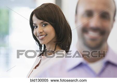 Stock Photography - Business people smiling in office. Fotosearch