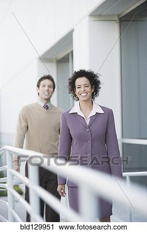 Business people smiling on walkway View Large Photo Image Stock Image - Business people smiling on walkway. Fotosearch