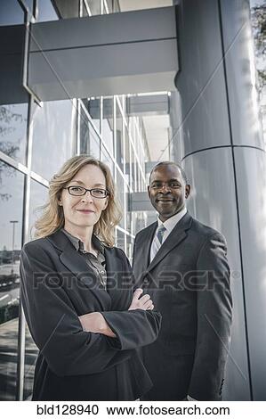 Business people smiling outside office building View Large Photo Image Stock Image - Business people smiling outside office building. Fotosearch