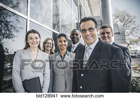 Business people smiling outside office building View Large Photo Image Stock Image - Business people smiling outside office building. Fotosearch