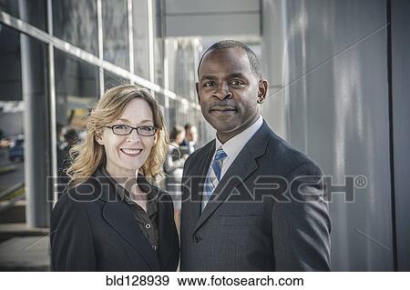 Business people smiling outside office building View Large Photo Image Stock Photo - Business people smiling outside office building. Fotosearch