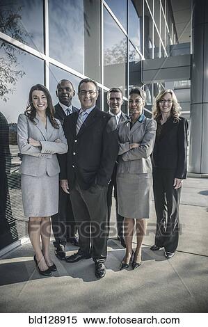 Stock Photography - Business people smiling outside office building. Fotosearch