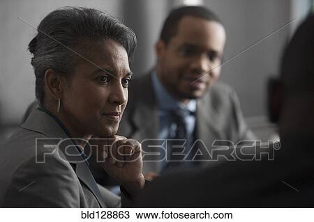 Stock Image - Business people talking in meeting. Fotosearch