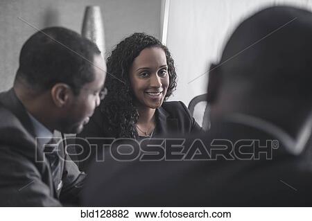 Stock Image - Business people talking in meeting. Fotosearch