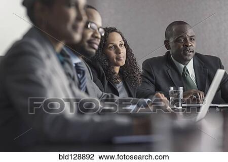 Stock Image - Business people talking in meeting. Fotosearch