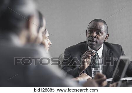 Stock Photography - Business people talking in meeting. Fotosearch