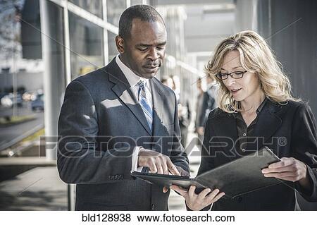Stock Photo - Business people talking outside office building. Fotosearch