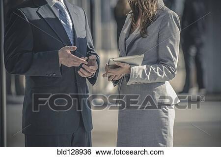 Business people talking outside View Large Photo Image Stock Photograph - Business people talking outside. Fotosearch