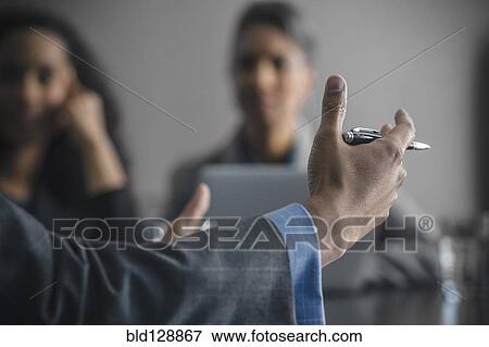 Businessman gesturing in meeting View Large Photo Image Stock Photo - Businessman gesturing in meeting. Fotosearch