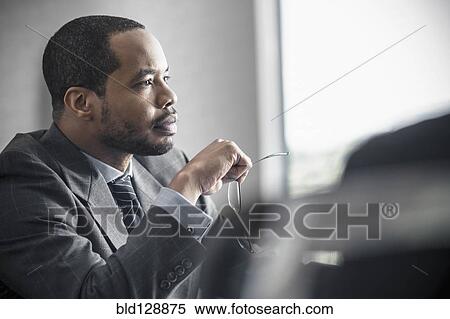 Stock Photography - Businessman sitting at desk. Fotosearch