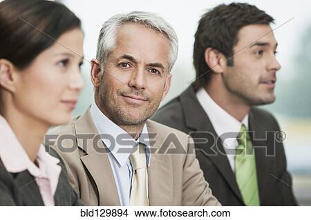 Picture - Businessman sitting in meeting. Fotosearch