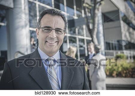 Businessman smiling outdoors View Large Photo Image Stock Image - Businessman smiling outdoors. Fotosearch