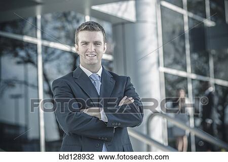 Stock Image - Businessman smiling outdoors. Fotosearch