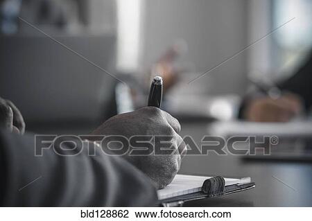 Businessman taking notes in meeting View Large Photo Image Stock Image - Businessman taking notes in meeting. Fotosearch