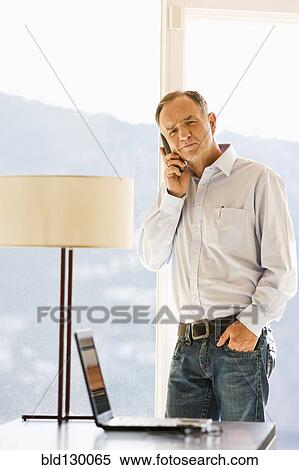 Stock Photography - Businessman talking on cell phone. Fotosearch