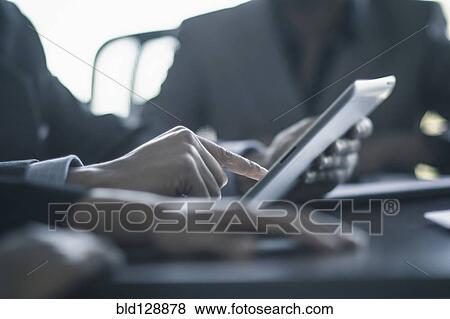 Businessman using digital tablet in meeting View Large Photo Image Stock Photo - Businessman using digital tablet in meeting. Fotosearch