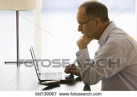 Businessman working at desk View Large Photo Image Stock Photo - Businessman working at desk. Fotosearch