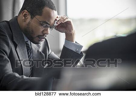 Stock Photo - Businessman working in office. Fotosearch