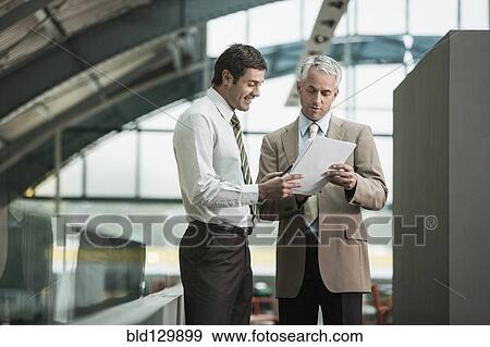 Businessmen talking in office View Large Photo Image Stock Photo - Businessmen talking in office. Fotosearch