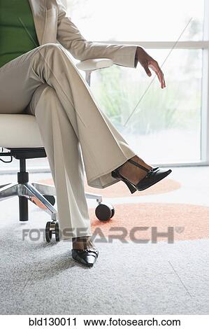 Businesswoman sitting in office View Large Photo Image Stock Image - Businesswoman sitting in office. Fotosearch