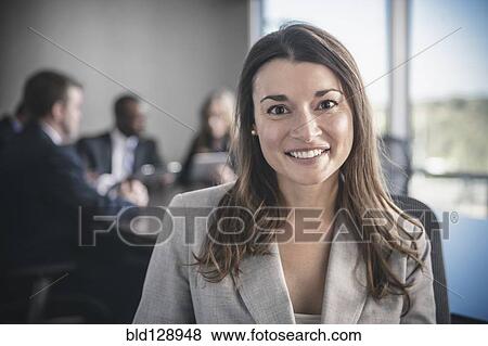 Businesswoman smiling in conference room View Large Photo Image Stock Photo - Businesswoman smiling in conference room. Fotosearch