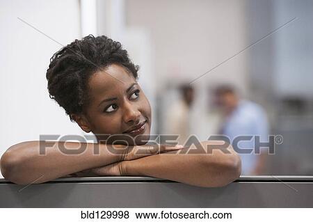 Stock Photo - Businesswoman smiling in office. Fotosearch